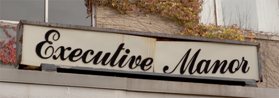 Executive Manor apartment building sign