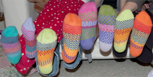 several feet in colorful socks